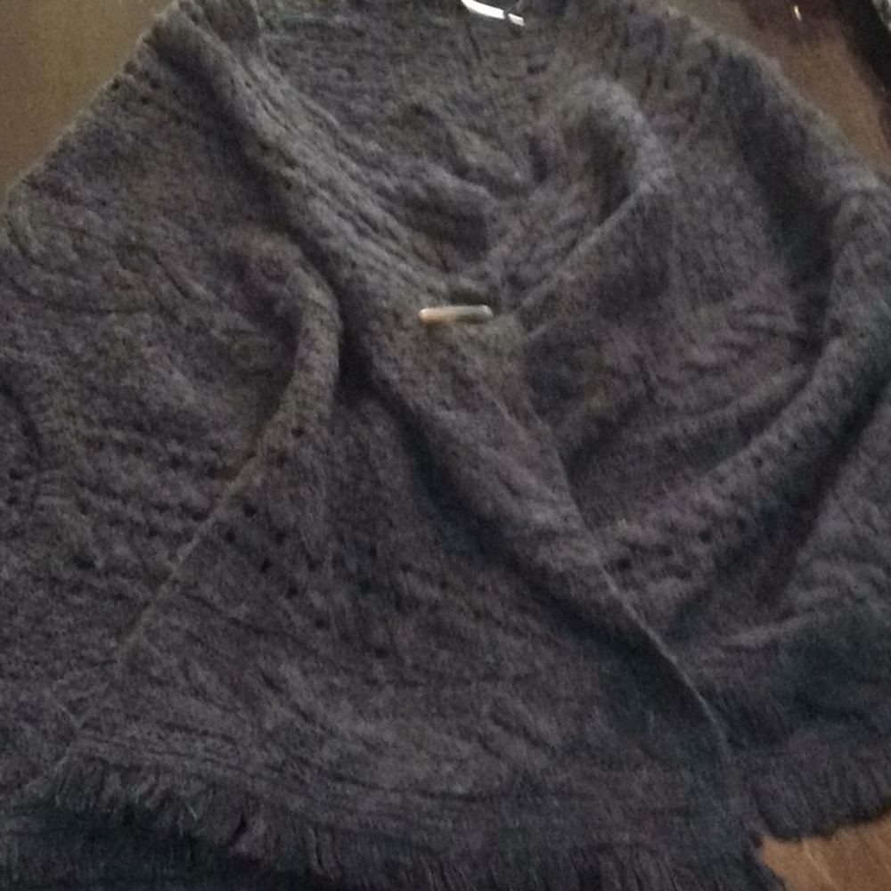 Pancho with sleeve hole and button